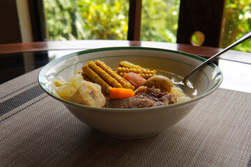 Typical Costa Rican soup called olla de carne with corn, potato, chayote, green plantain, carrot, typical Mexican and Central American food, broth called caldo de res or meat soup