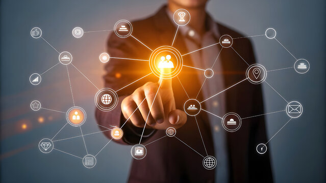 Businessman interacting with a glowing network of digital connections and modern technology icons