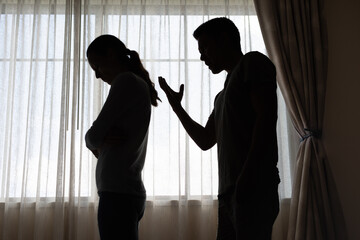 unhappy crying frightened woman, aggressive man quarreling at home. Angry husband emotionally...