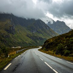 Naklejka premium Winding mountain road in a misty landscape