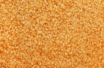 Organic brown sugar as background, top view. Texture of cane sugar.