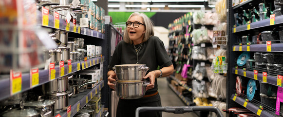 Shopping for kitchen supplies in a home goods store during the afternoon with a joyful customer