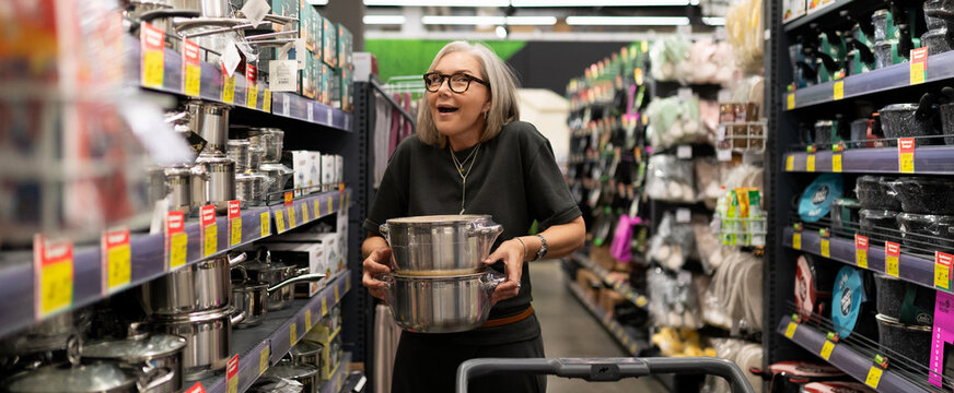 Shopping for kitchen supplies in a home goods store during the afternoon with a joyful customer
