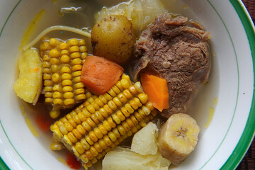 Close-up of a typical Costa Rican soup called Olla de Carne, a typical Costa Rican dish with white rice, chayote potatoes, carrots, and green plantains. Beef soup with vegetables,mexican soup