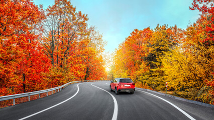 car drive on autumn road in beautiful nature. autumn colors in beautiful mountain road landscape. autumn landscape on the highway in forest. nature trip in fall. Autumn panorama on highway landscape.
