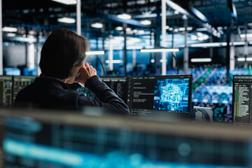 Data center programmer drinking coffee while managing artificial intelligence training datasets. IT...