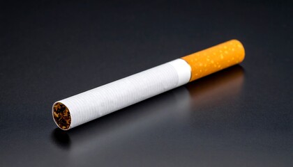 Single cigarette on dark surface