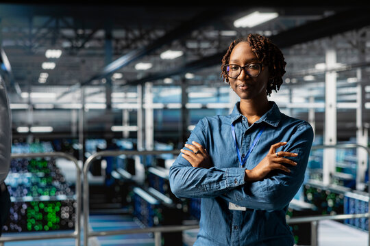 Portrait of african american engineer ensuring server hub automation, reviewing AI LLM visualizations in data center. IT professional analyze neural network systems for infrastructure. - Powered by Adobe