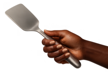 Hand holding a sleek metal kitchen spatula, isolated on transparent background
