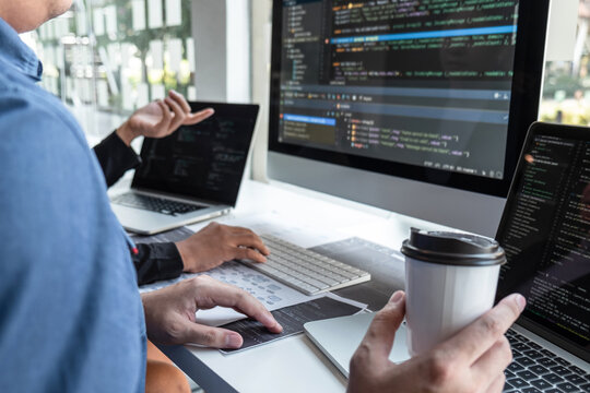 Team of developer programmer working on project in software development computer in IT company office, Writing codes and data code website and coding database technologies to find problem solution