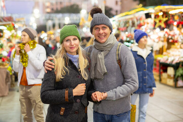 Portrait of happy married couple at christmas street fair