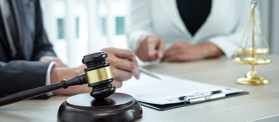 Male lawyer or counselor discussing negotiation legal case with client meeting with document contract in office, law and justice, attorney, lawsuit concept