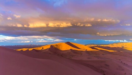 Dramatic sunset over a vast expanse of golden sand dunes, bathed in warm hues and dramatic clouds.