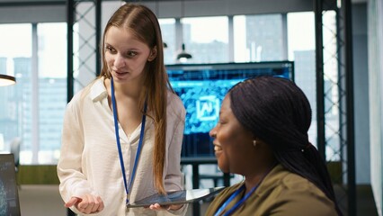 Manager teaching young technician how to develop software and optimize code using AI. Team leader guiding intern in office on how to use artificial intelligence to resolve bottlenecks, camera A