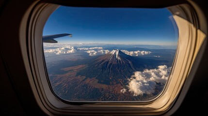High-altitude view of a volcano through an airplane window.