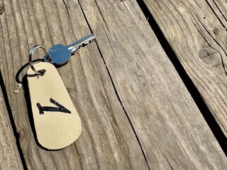Metal keys with label number one placed on rustic wooden surface 