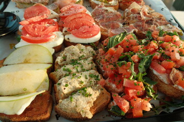 Delicious platter of food with bread and fixings on top, catering food at a party
