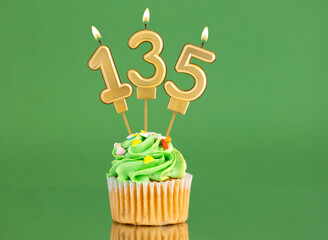 Birthday card with candle and cupcake - Number 135 on a green background