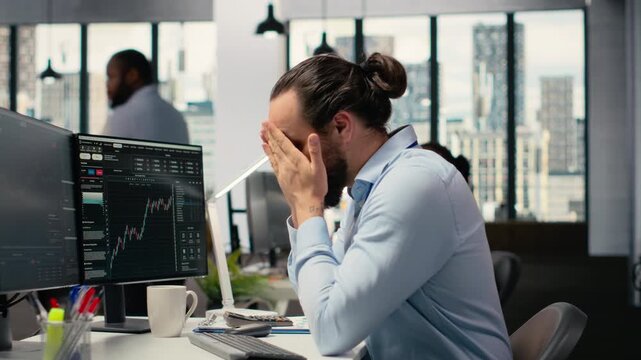 Trader covering face in disbelief, concerned by investment portfolio value drop after unexpected market crash. Upset financial expert distressed by stock exchange account losses, camera B - Powered by Adobe