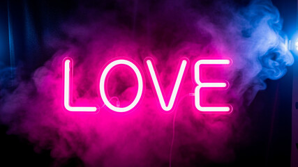 Love neon sign in pink smoke on dark background