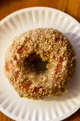 Close-up of butternut donut on paper plate
