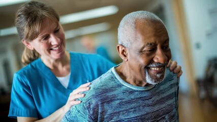 Smiling nurse providing support to a cheerful senior man during rehabilitation exercises in a nursing home, fostering health and promoting recovery in later life