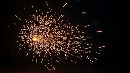 An industrial workshop with glowing sparks, showcasing dynamic energy in a dark environment.