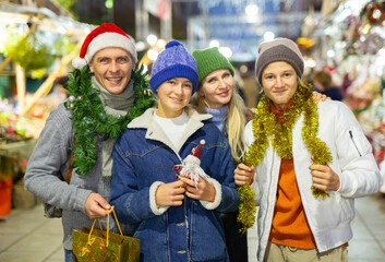 Portrait of smiling family with teenager girl and boy standing at Christmas fair