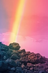 Rainbow over volcanic rocks, sunset sky, coastal scene, serene nature