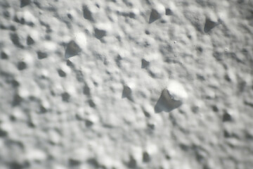 Macro shot of white rough wall texture as background