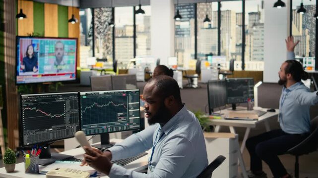 Stockbrokers worried by Black Swan event causing global disruption, alerting customers. Prop firm traders watch breaking news of crisis affecting stock market, desperately calling clients, camera A