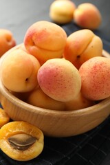 Fresh ripe apricots in bowl on table, closeup