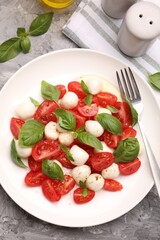Tasty salad Caprese served on grey table, flat lay