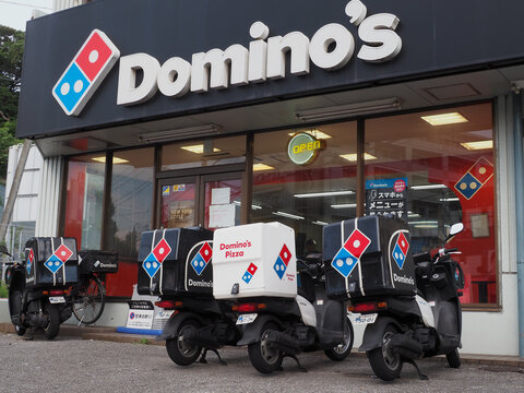 CHIBA, JAPAN - August 18, 2025: Domino's Pizza restaurant with delivery scooters in front of it in Chiba City.