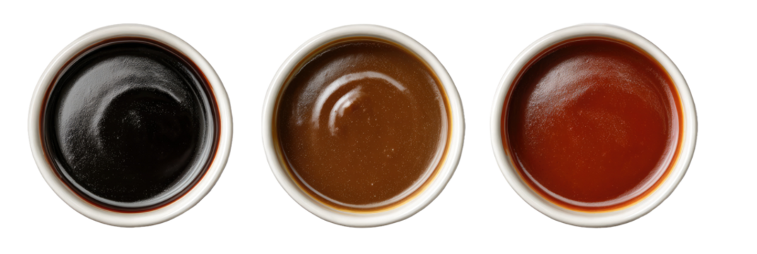 Three small white bowls of different sauces