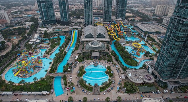 Aerial View of Yas Waterworld, Abu Dhabi, with Modern Skyscrapers and Vibrant Water Slides