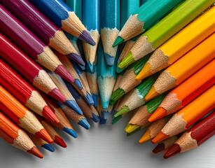 Rainbow collection of colored pencils arranged in corner frames on white background. Variety of shades, bright colors, perfect for education, creativity, art projects. Copy space available for text.