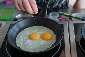 The chef fries the eggs sunny side up. 