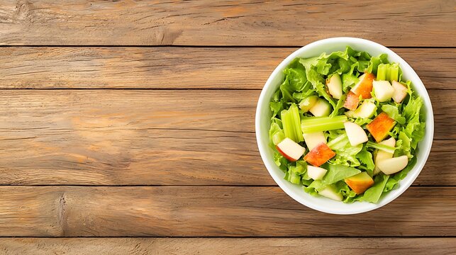 A fresh salad with apple and celery in a bowl on a wooden table - Powered by Adobe