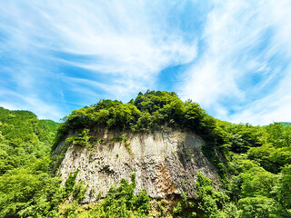 がんだて公園の巨大な岩壁と穏やかな空模様