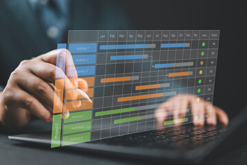 Project manager works and updates tasks with milestones and progress planning. Businessman draw Gantt chart scheduling virtual diagram, project management concept.