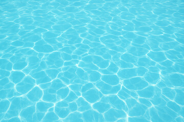 Refreshing summer swimming pool water background with sunlight reflections
