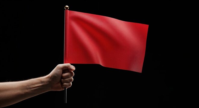 Red Flag Waving: A hand firmly grips a vibrant red flag against a stark black backdrop, symbolizing a warning, danger, or signal for caution and action. The image speaks of critical alerts. - Powered by Adobe