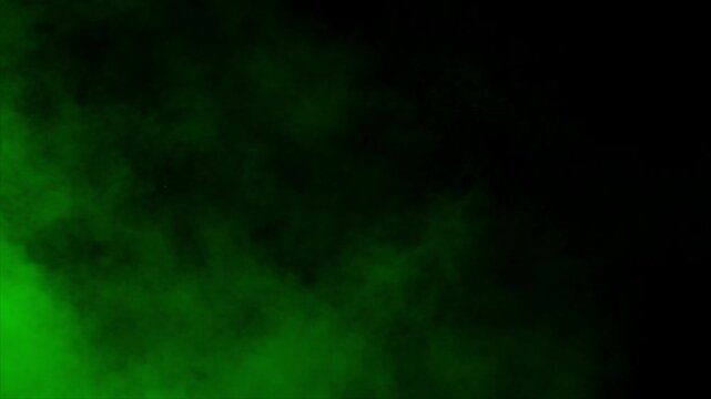 Realistic green smoke mist or fog drifts and swirls on black background. Ideal for overlays, special effects, and creating a mysterious, toxic, poison, radioactive or magical atmosphere