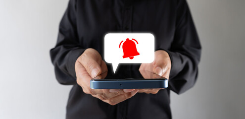Receiving multiple notifications. Businesswoman holding smartphone. With a notification bell icon floating inside a speech bubble.