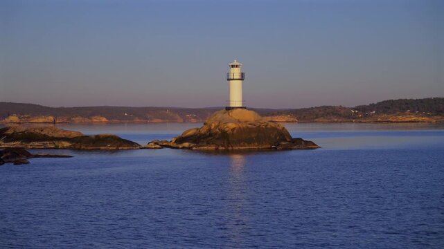 Lighthouse Str&ouml;mstad Stromstad Fjord Ursholmen Sweden sea ferry boat ride land of the Svea Sverige calm sea ocean water late arctic afternoon sunset Nordkoster enchanting coastal beauty circle motion