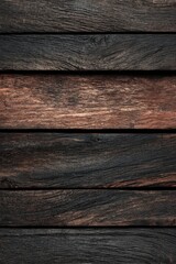 Fototapeta premium Close-up of aged, dark wooden planks. Horizontal, weathered wood grain. Intensely dark tones with hints of reddish-brown