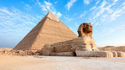 Papier peint photo Egypte Majestic pyramid and sphinx under clear blue sky, showcasing ancient architecture and history  © siraphol