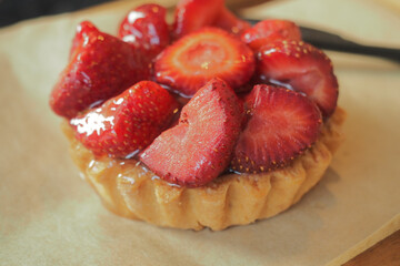 Freshly baked strawberry tart on a wooden surface