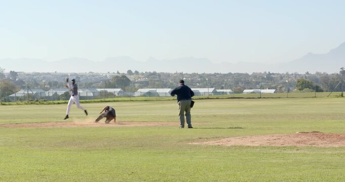 White male pitcher pitching for out, batter running, baseman tagging runner, umpire calling out